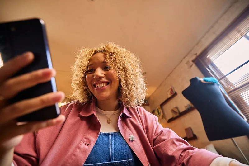 A video call, a professional smiling at the camera